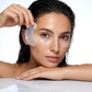 Woman applying eye patches with a white background